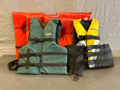 (4) Adult Universal Life Vests, (1) Cabelas Adult Life Vest and (1) Adult Free Motion Life Vest