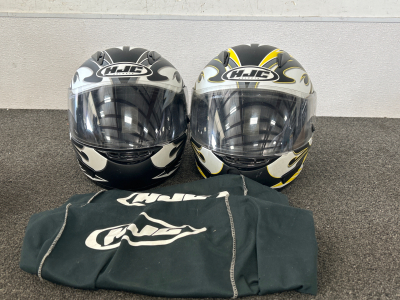 2 HJC Motorcycle Helmets in Excellent Condition!! Black and White is size Small, Black/Yellow/White Size Large. Soft Storage Sacks Included!!