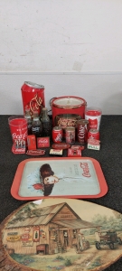 Wooden Coca-Cola Picture. Vintage Metal Coca-Cola Tray. Vintage Coca-Cola cans. Coca-Cola salt & pepper shakers. Coca-Cola magnets. Coca-Cola plastic cups. Coca-Cola glass bottles unopened. Coca-Cola lamp (minor damage to the top portion). Coca-Cola bucke