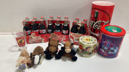 Coca-Cola Collectibles: (2) 6-Pack Full Glass Bottles, (1) 4-Pack Full Glass Bottles, (2) Tins, (1) Cardboard Roll, (4) International Toys, (1) Pint Glass